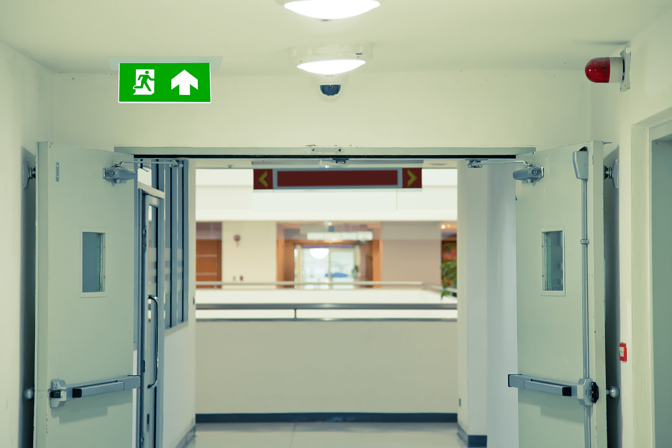 Green emergency fire exit sign or fire escape with the doorway or door exit in the building concepts for evacuation in the event of a fire.